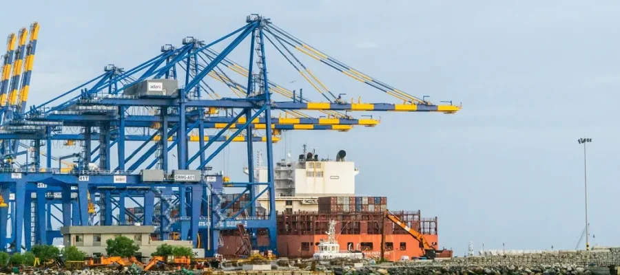 A tugboat from Vizhinjam Port rescues a trapped maritime enforcement vessel in rough waters.